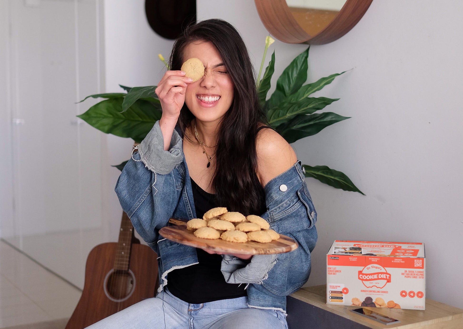Lady smiling holding tray of cookies